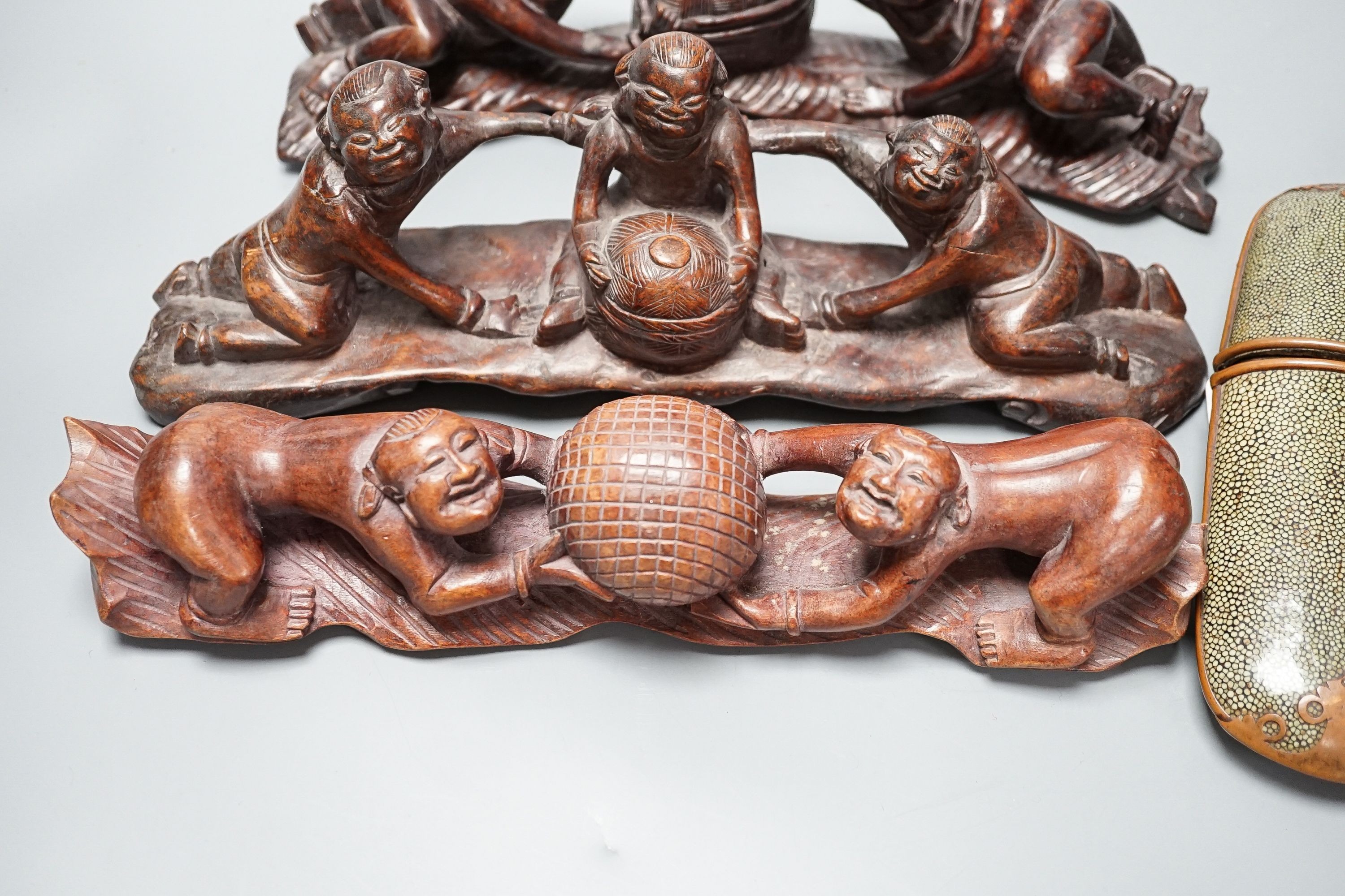 Two Chinese Qing spectacle cases, 19cm, and three hardwood carvings of boys